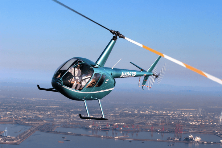 a helicopter flying over a body of water