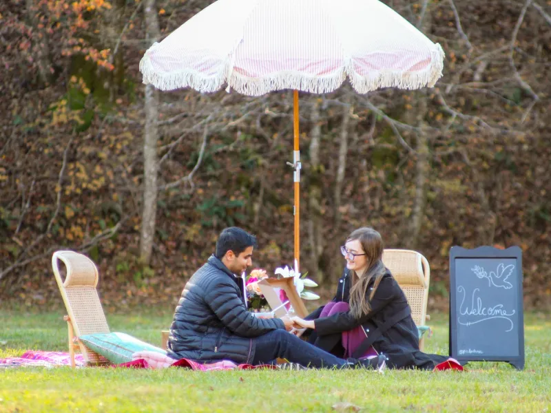 a couple of people that are sitting in the grass